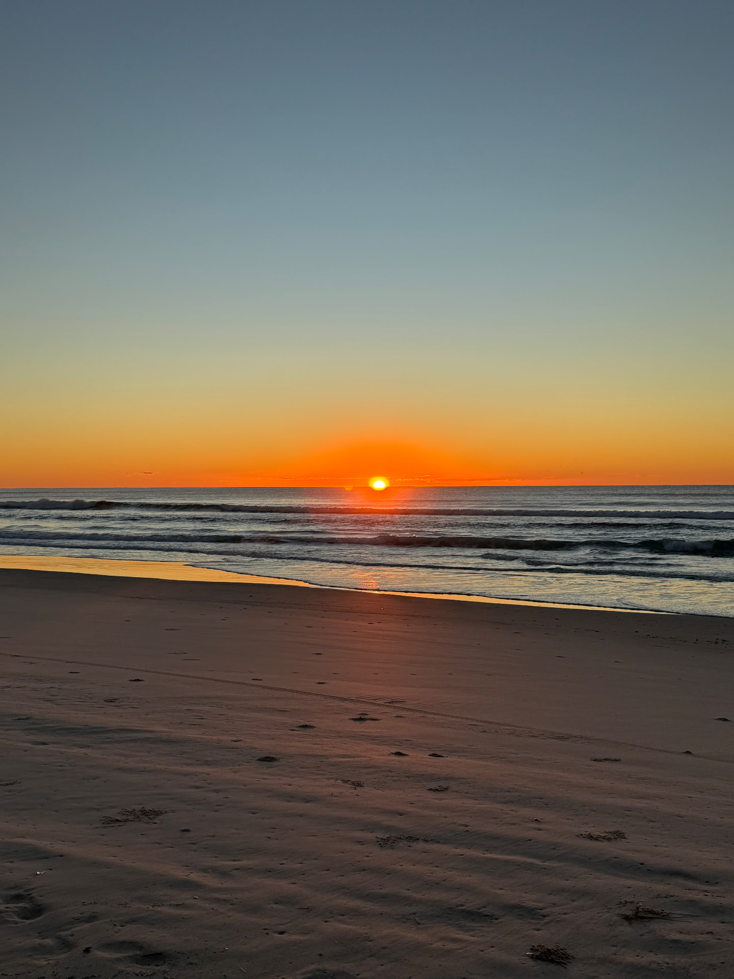 Private yoga session setting on a Byron Bay beach at golden hour