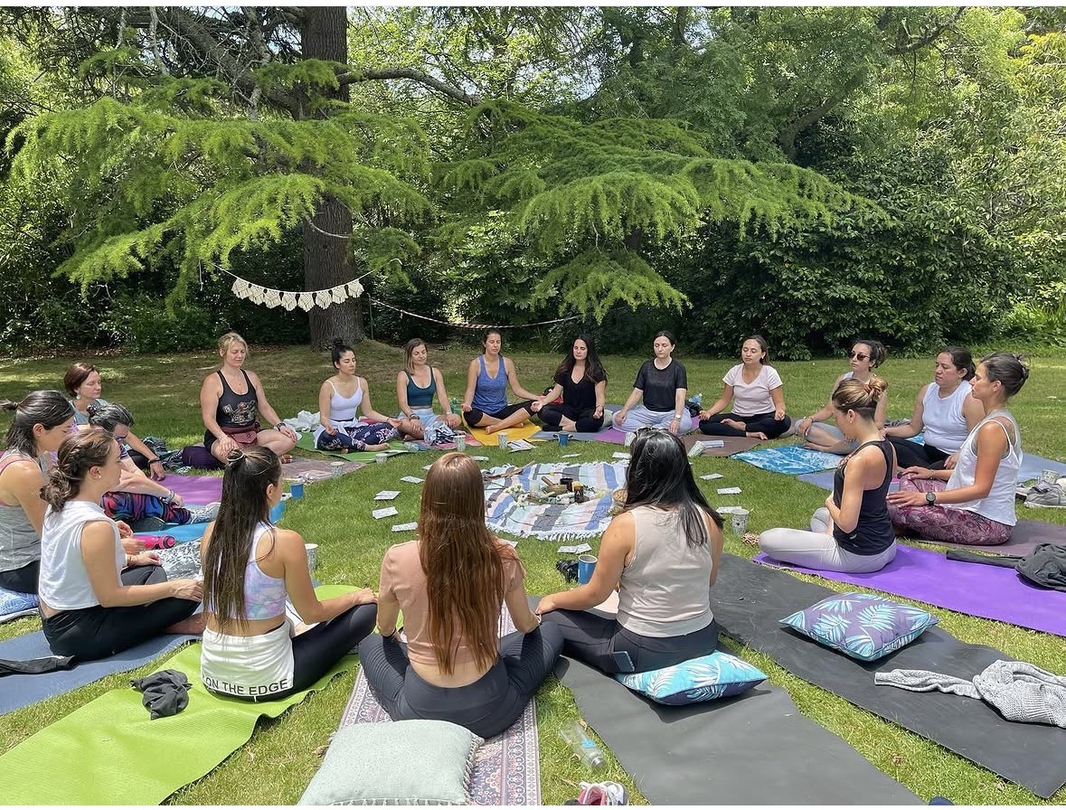 Group meditation and breathwork circle in Byron Bay under the trees